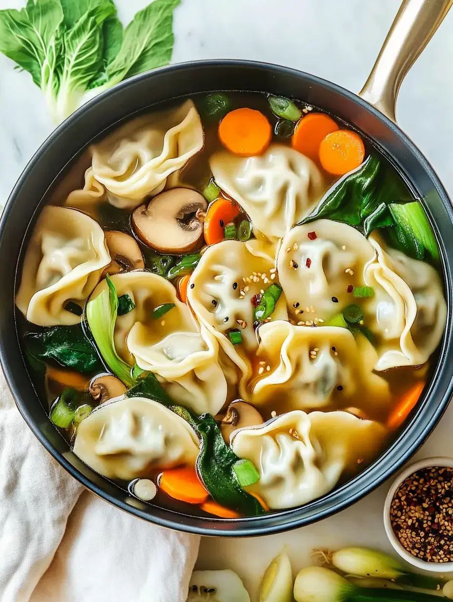 A pot of broth-filled soup with dumplings, mushrooms, carrots, and leafy greens on a marble surface.