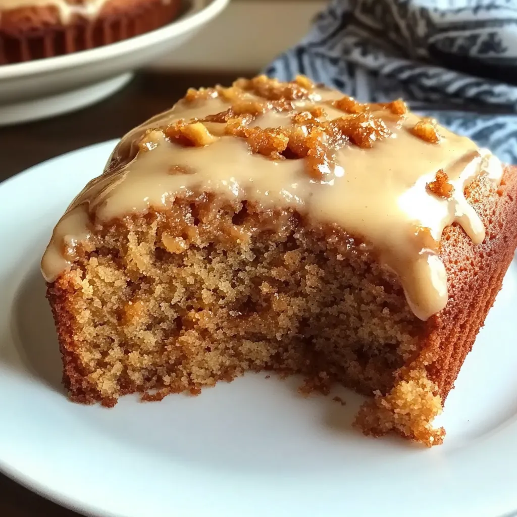 A slice of applesauce cake on a white plate.