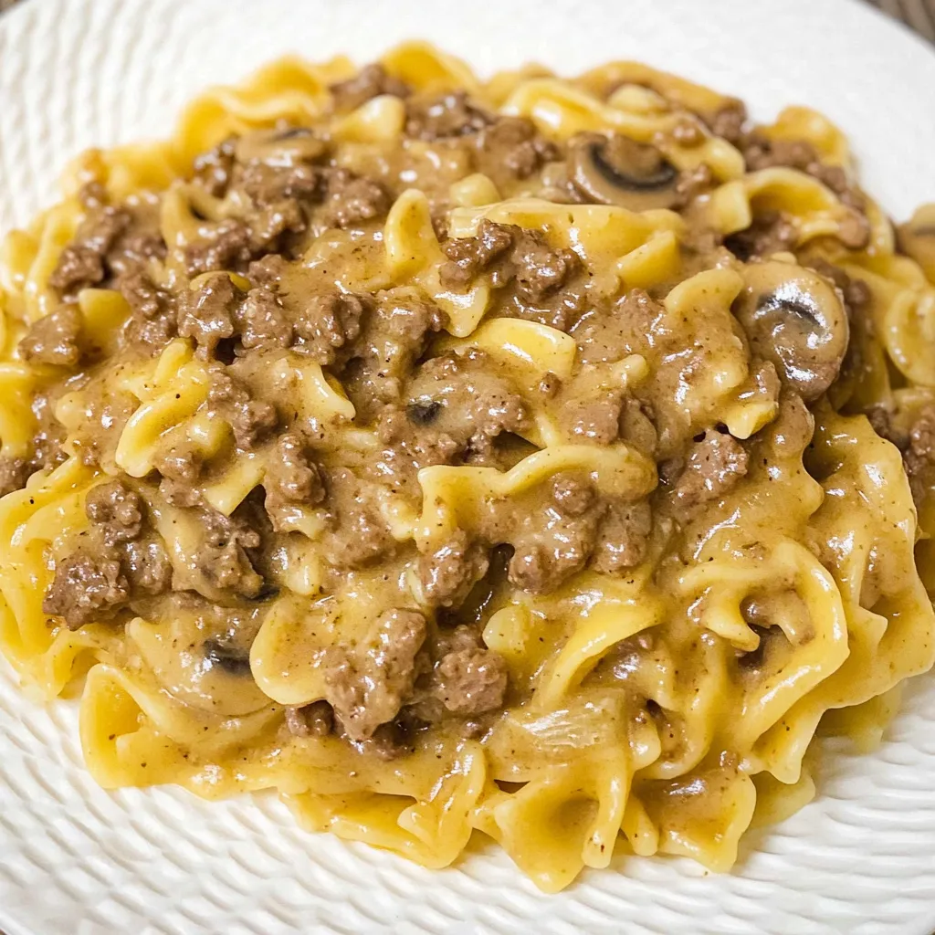 A plate of pasta with meat sauce.