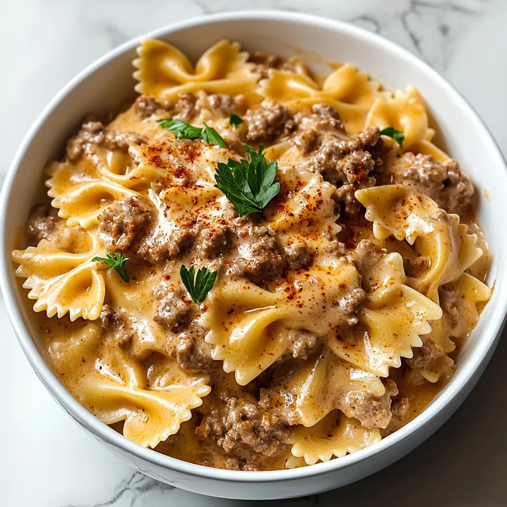 A bowl of pasta with meat and cheese.