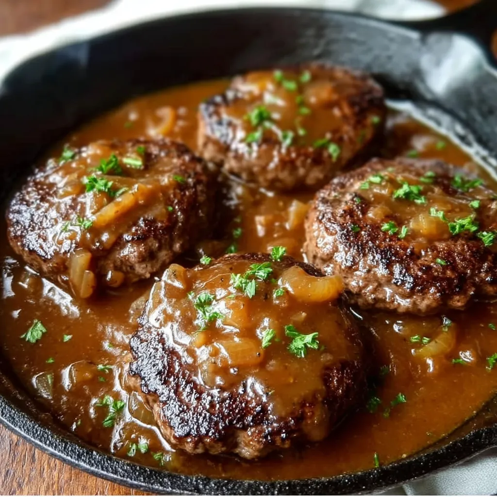 A pan of meat with gravy.