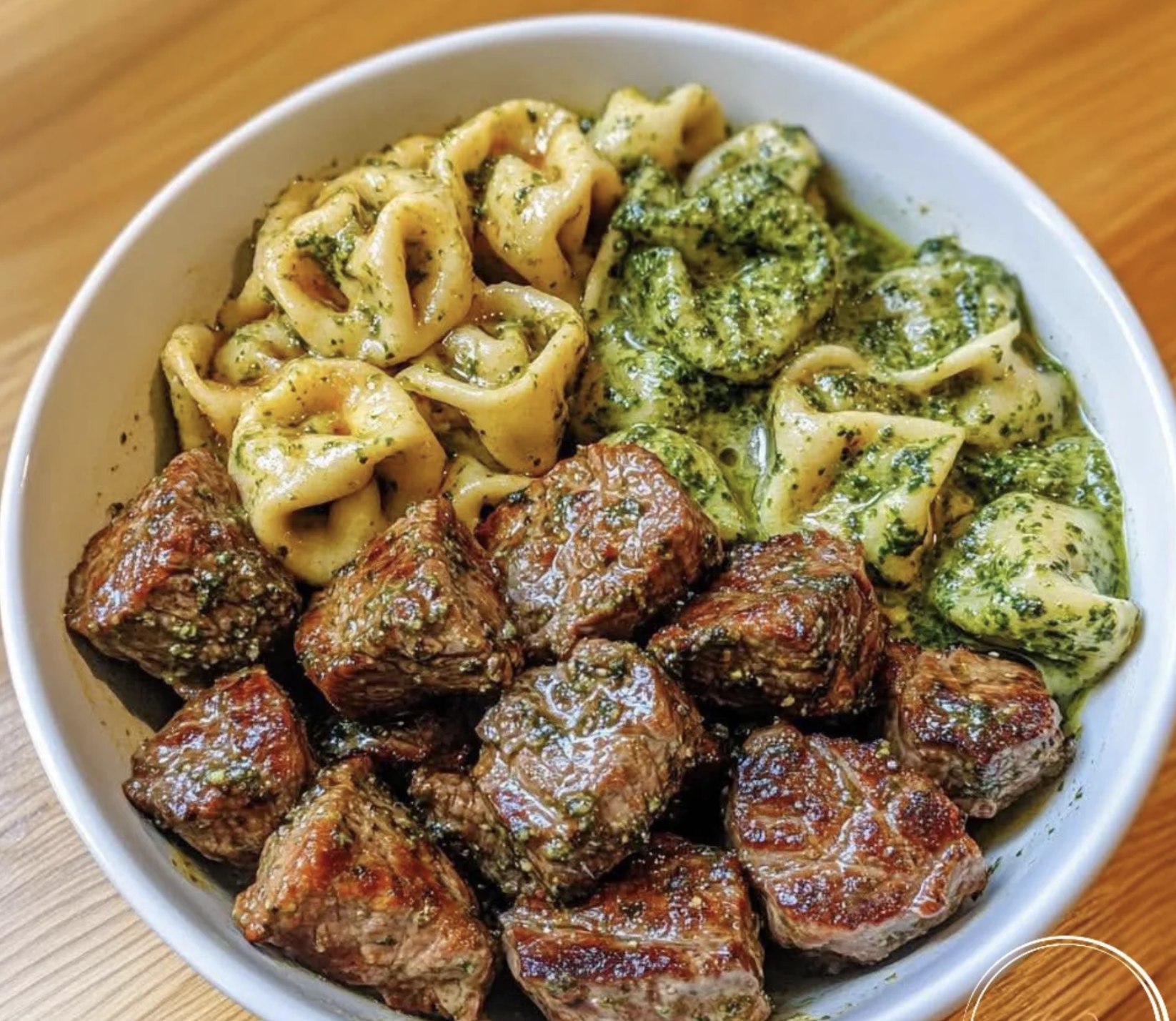 A bowl of pasta with meatballs.