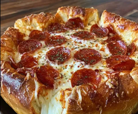 A pizza pie with pepperoni and cheese.