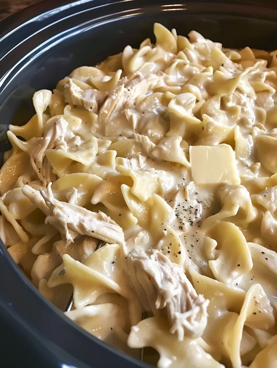 A bowl of pasta with chicken and cheese.