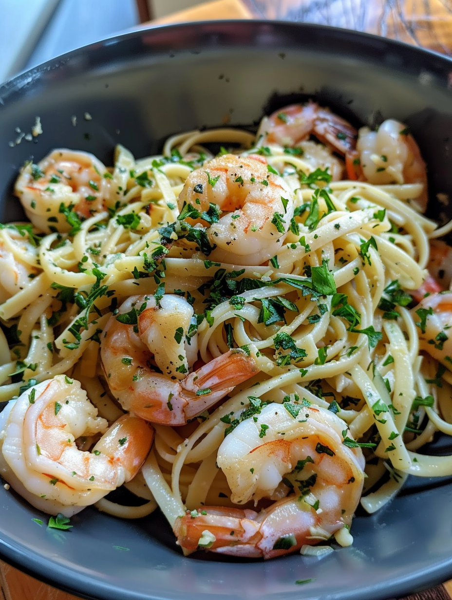 A bowl of shrimp and noodles.