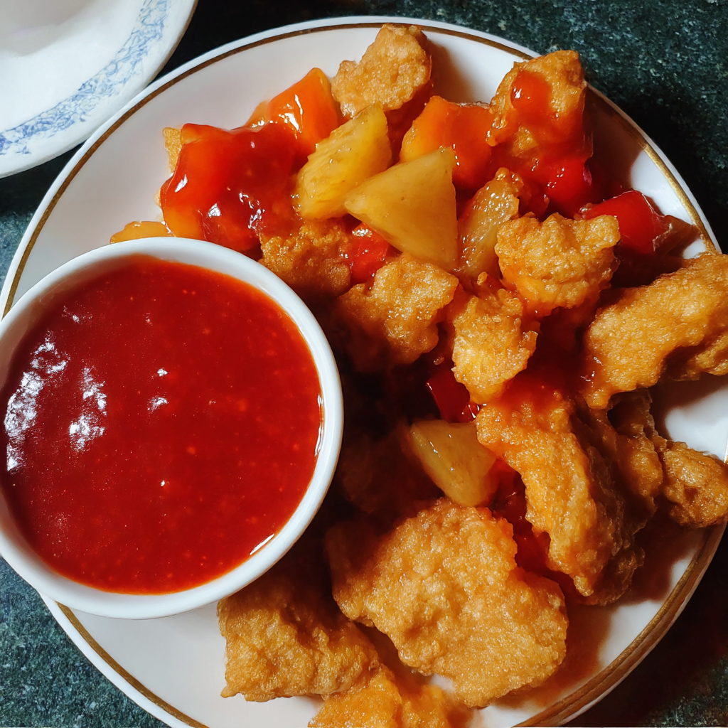 A plate of food with a bowl of sauce.