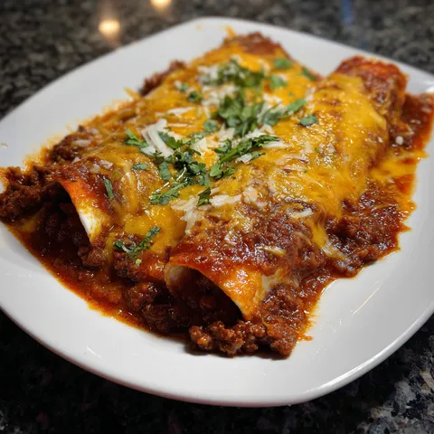 A plate of food with a burrito on it.