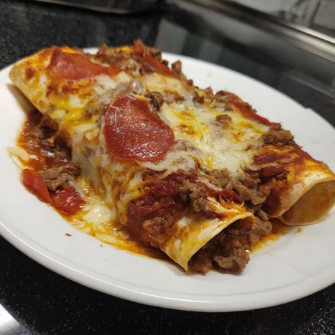 A plate of food with pepperoni and cheese.