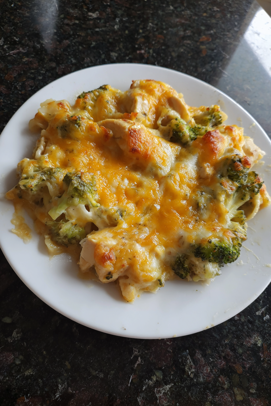 A plate of food with broccoli and cheese.