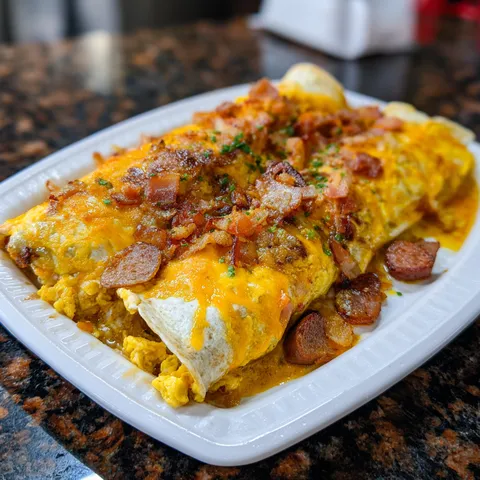 A plate of food with bacon and cheese.