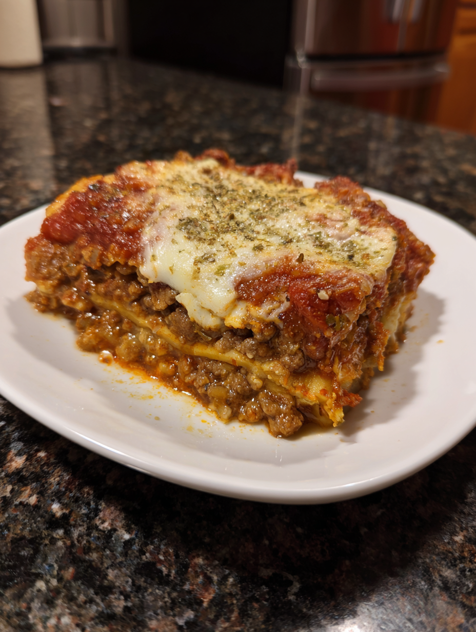 A slice of lasagna on a plate.