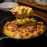 A fork is in a pan of food.