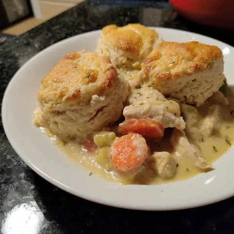 A plate of food with biscuits and vegetables.
