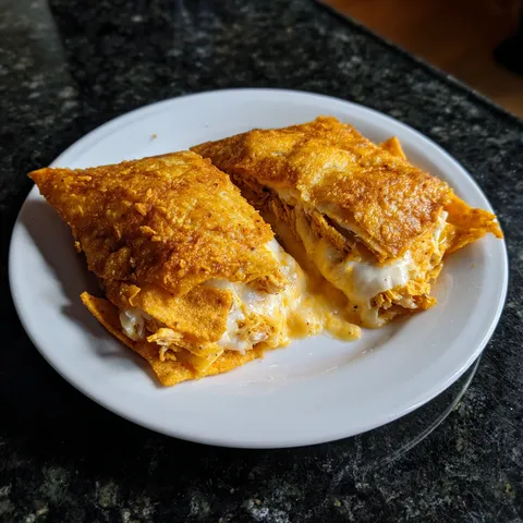 A white plate with two pieces of food on it.