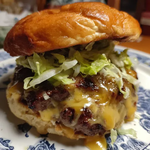 A burger with lettuce and cheese on a plate.