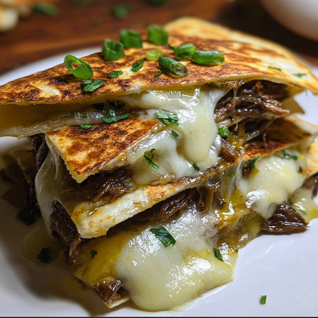 A stack of sandwiches with cheese and meat.
