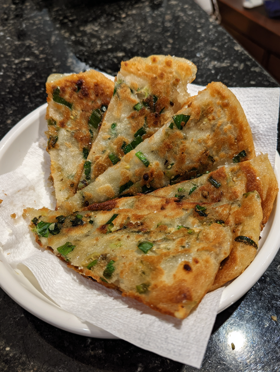 A plate of food with a white napkin underneath.