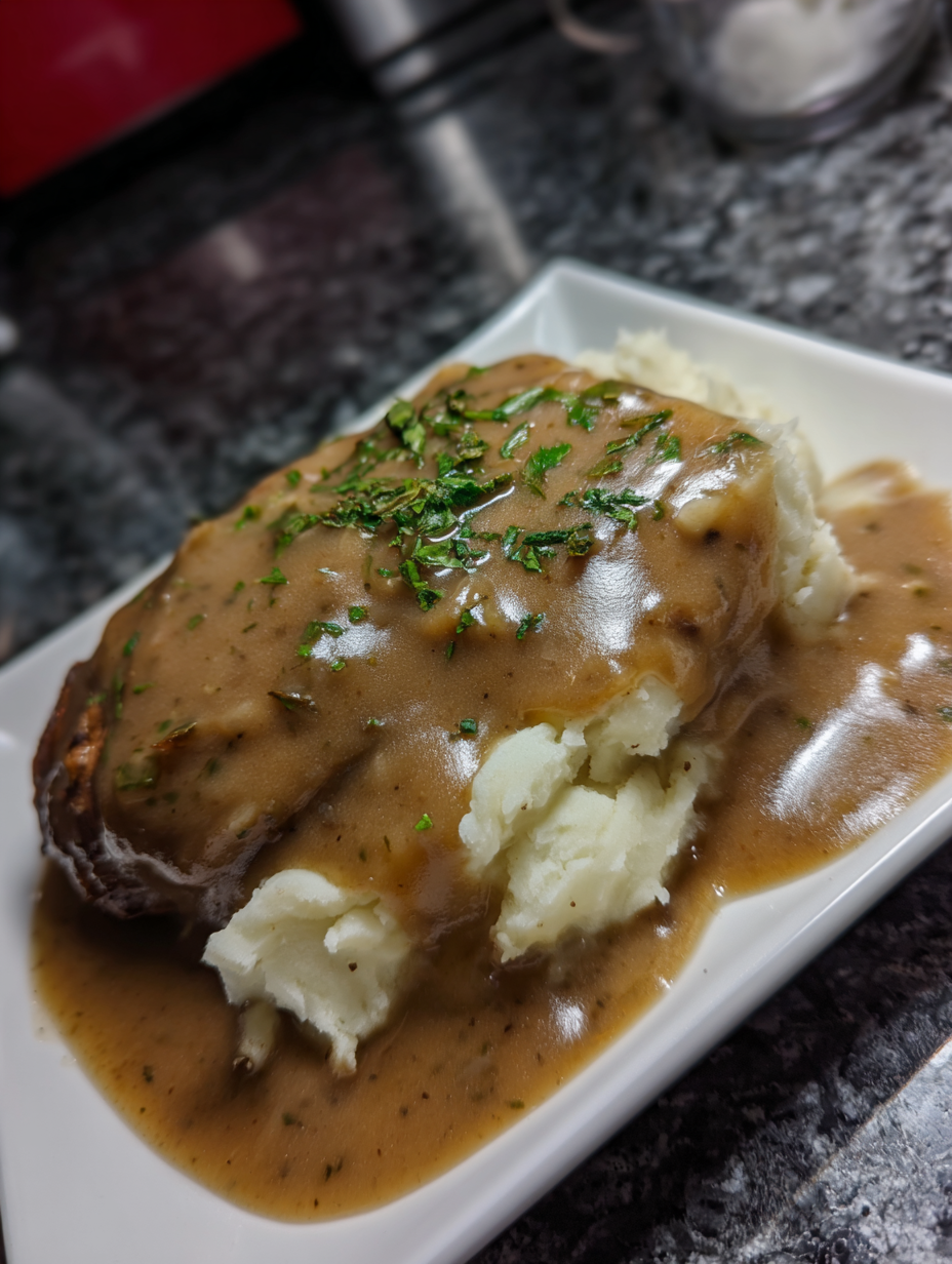 A plate of food with gravy on it.