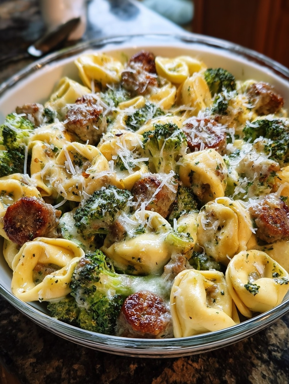 A bowl of pasta with broccoli and meat.