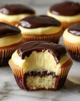 Cream-filled cupcakes with chocolate topping and pudding center